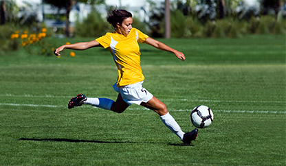 soccer player kicking ball